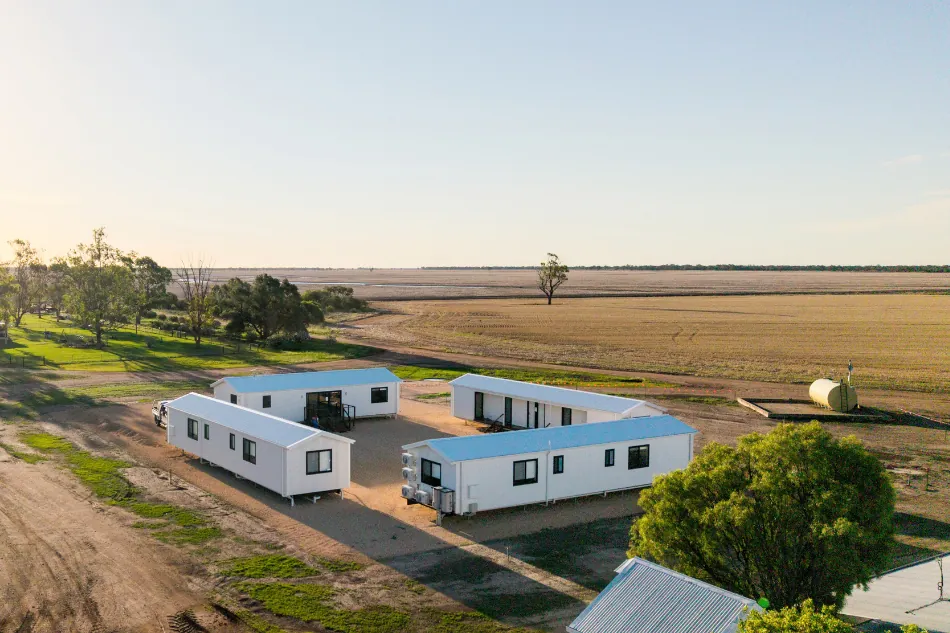 Modular worker housing on a regional farm with space planned for future accommodation.