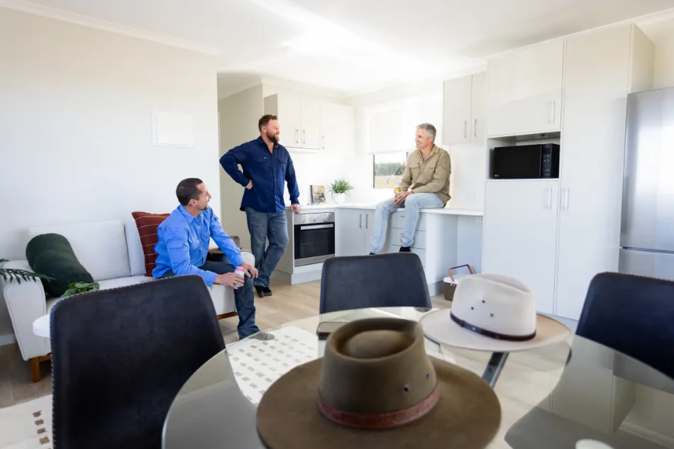 Shared kitchen and dining area separated from bedrooms in shift worker accommodation.